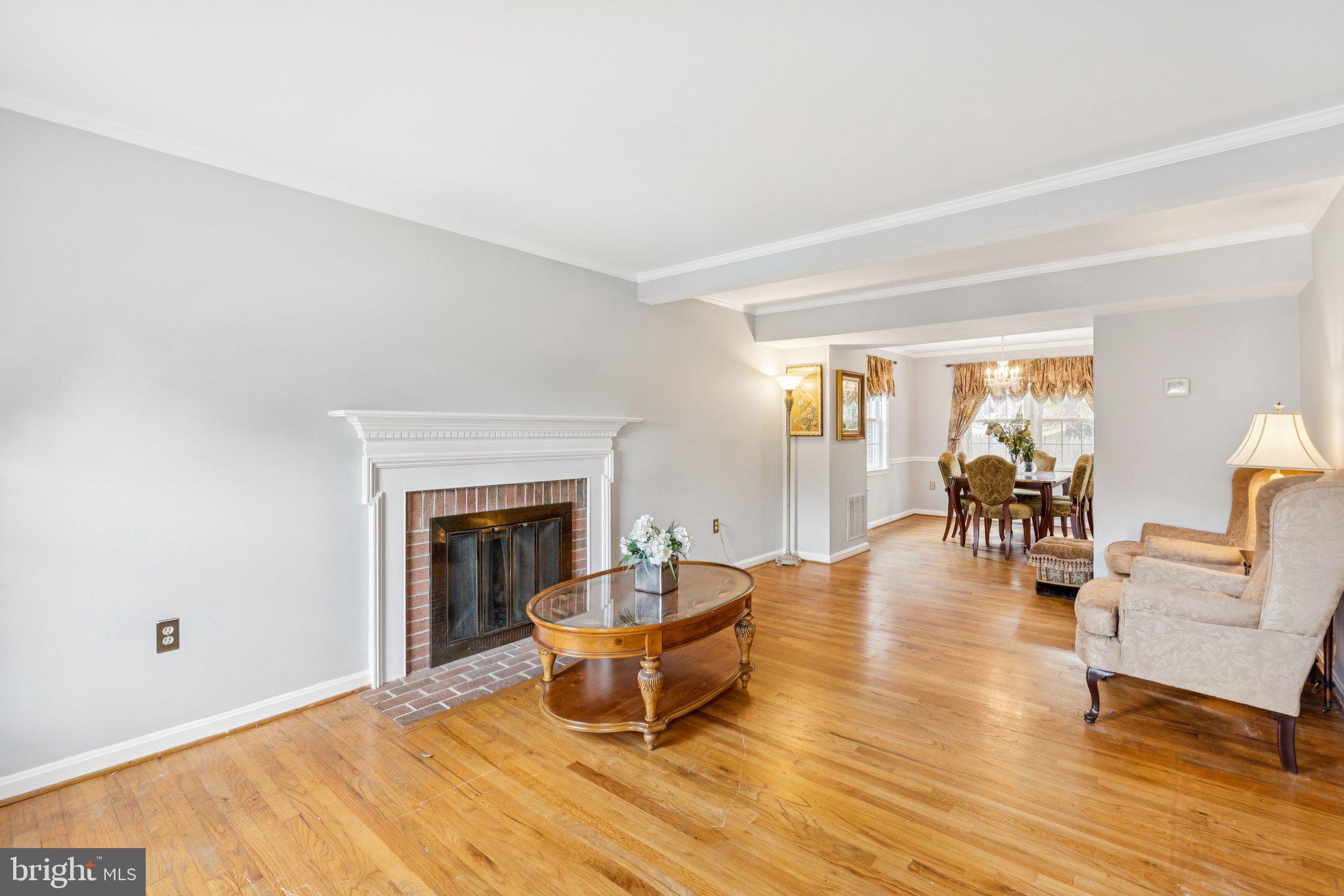 7029 Bradwood Court Springfield, VA 22151 - Photo 4 of 43 a living room with furniture and a fireplace
