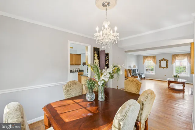 a view of a dining room with furniture wooden floor and chandelier