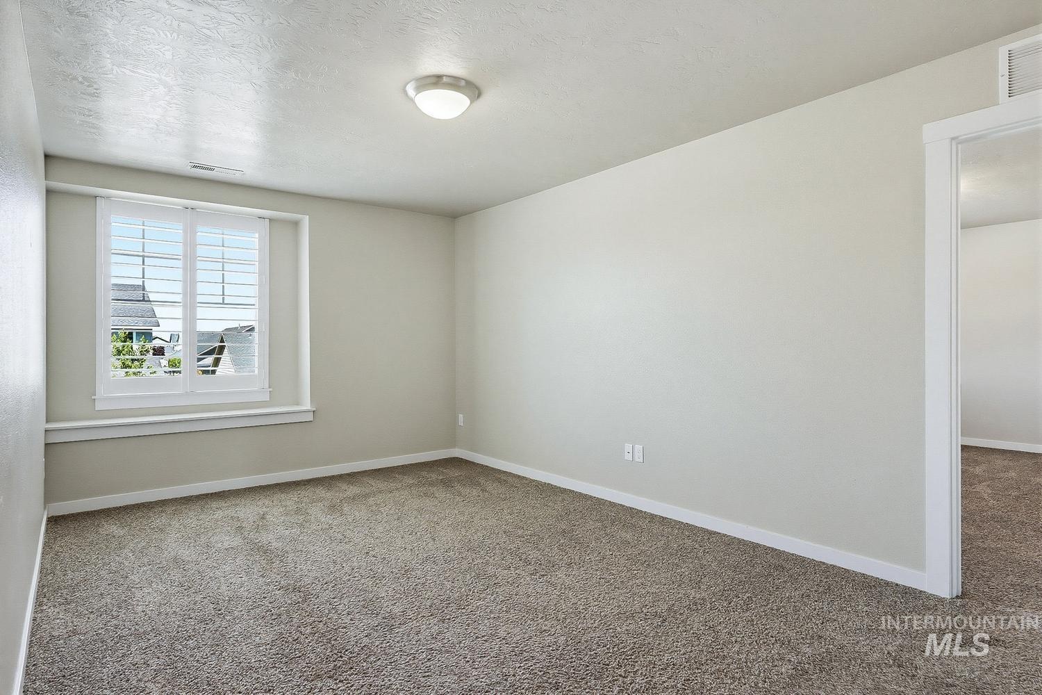 846 North Hidden View Way Star, ID 83669 - Photo 28 of 49 Carpeted interior room with neutral wall tones and white baseboards