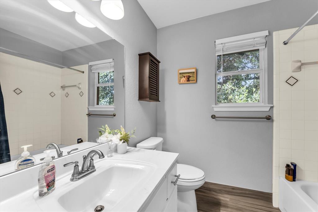 7 Market Loop Morgan's Point Resort, TX 76513 - Photo 21 of 31 Bathroom featuring a white vanity with a sink, brushed nickel faucet, faux wood-finish flooring, and light gray walls