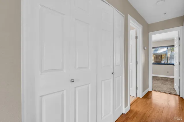 a view of a hallway with wooden floor