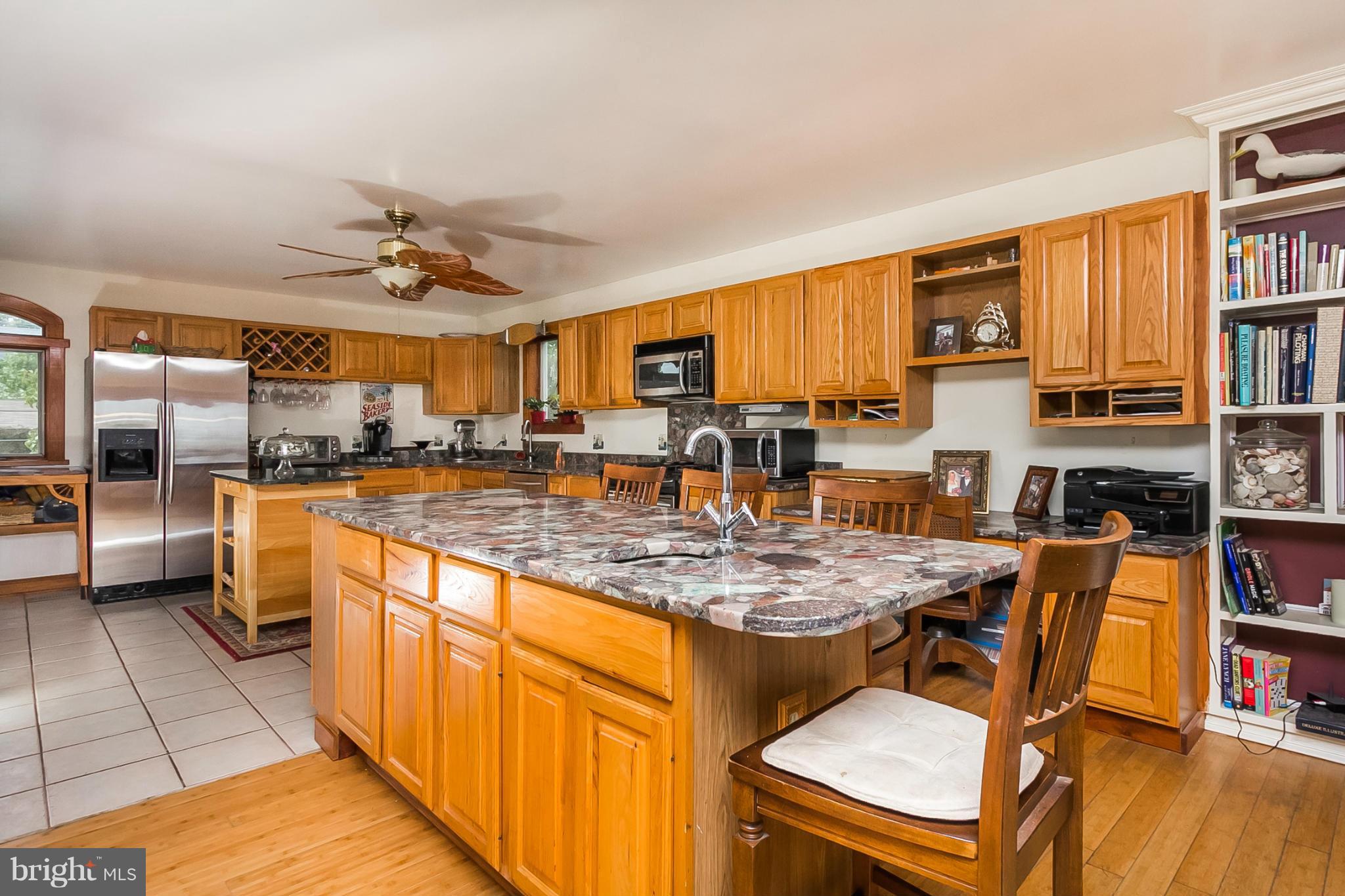 9103 Cuckold Point Road Baltimore, MD 21219 - Photo 5 of 28 a kitchen with stainless steel appliances granite countertop a stove and a refrigerator