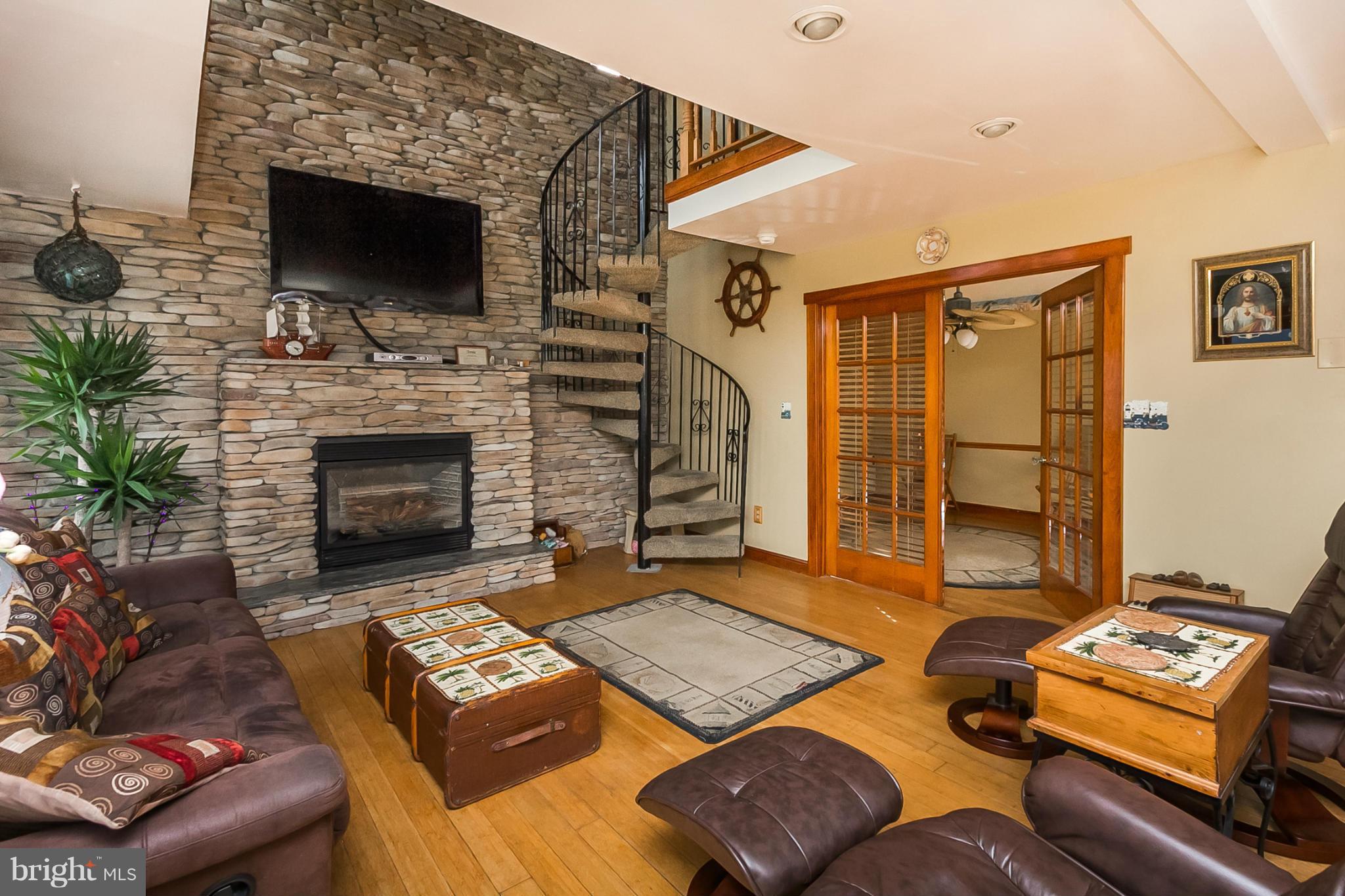 9103 Cuckold Point Road Baltimore, MD 21219 - Photo 10 of 28 a living room with furniture and a fireplace
