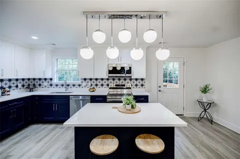 a kitchen with a table and chairs in it