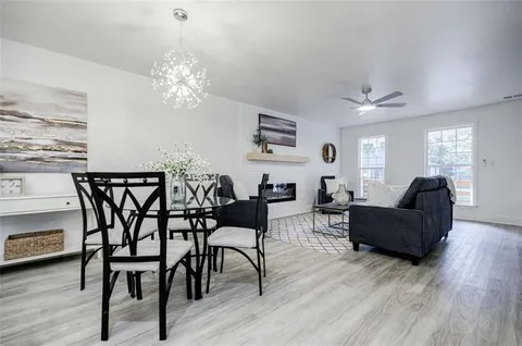 a kitchen with a stove a microwave and wooden floor