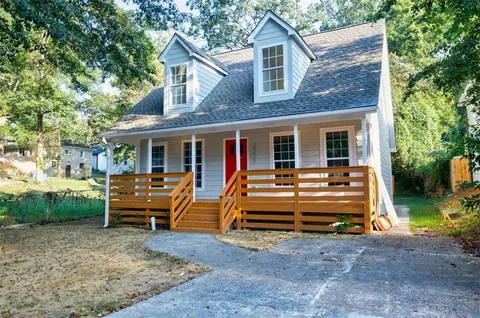 a view of house with outdoor seating area