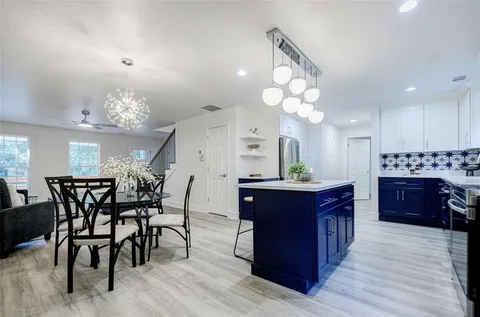a kitchen with a sink stove and cabinets