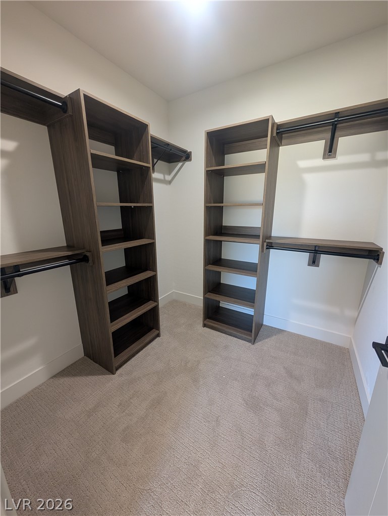 4670 Medicine Man Road Pahrump, NV 89048 - Photo 20 of 36 Ample storage solutions abound in this well-appointed walk-in wardrobe, featuring custom shelving and hanging rods.