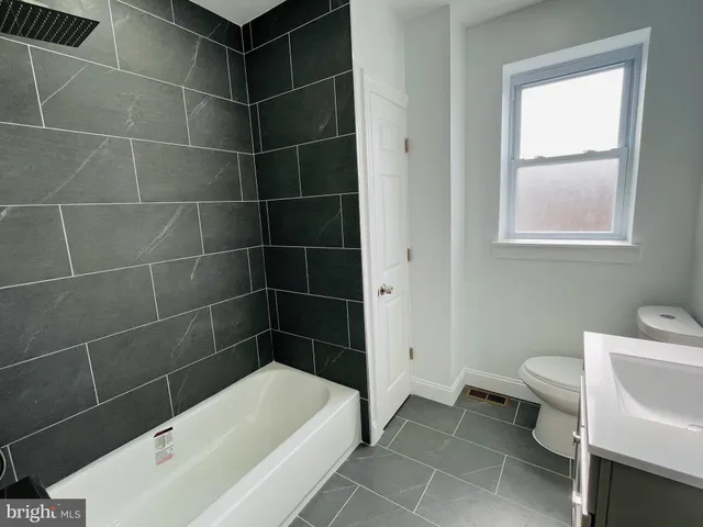 a bathroom with a bathtub and toilet