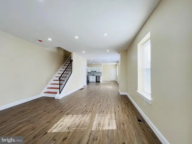 a view of a hallway with wooden floor and a piano