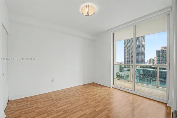 a view of a room with wooden floor and window
