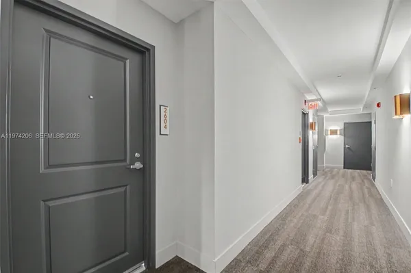 a view of hallway with wooden floor