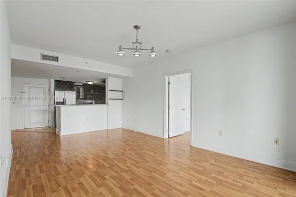 a view of a kitchen with a sink and wooden floor
