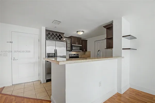 a kitchen with stainless steel appliances a refrigerator and a stove top oven