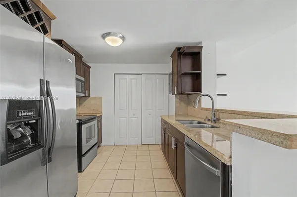 a kitchen with a refrigerator sink and stove