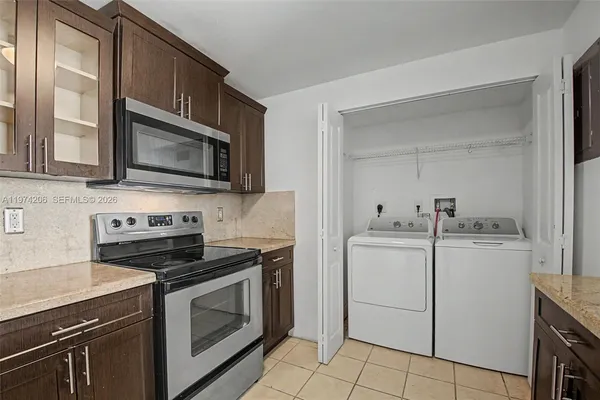 a kitchen with cabinets stainless steel appliances and a sink