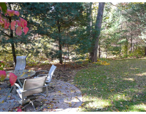 15 Spring Street Lexington, MA 02421 - Photo 15 of 16 a backyard of a house with table and chairs