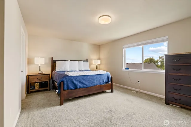 a bed sitting in a bedroom next to a window