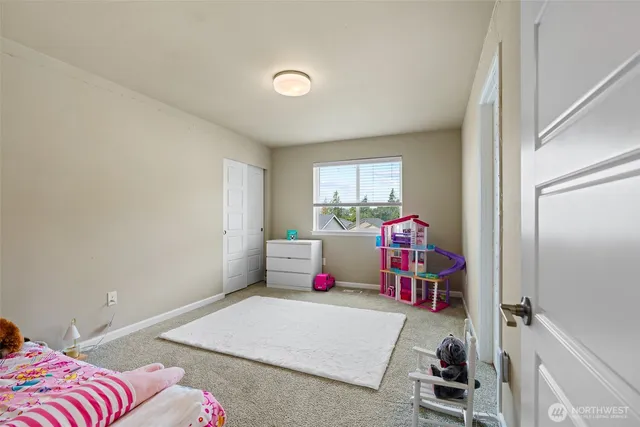 a bedroom with a bed and a couch