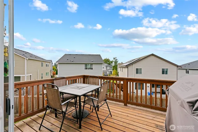 a view of a chairs and table on the roof deck