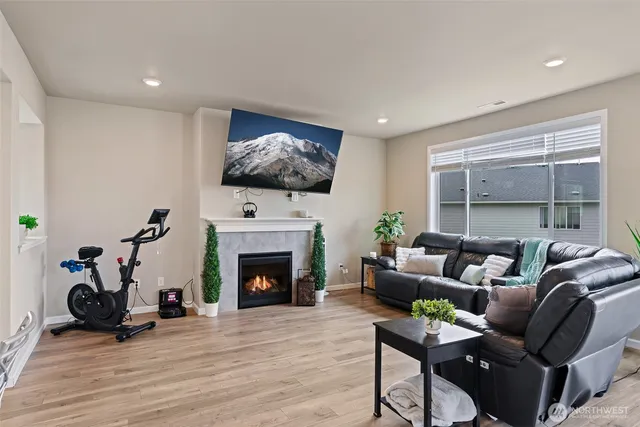a living room with furniture a fireplace and a flat screen tv