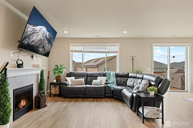 a living room with furniture a fireplace and a flat screen tv