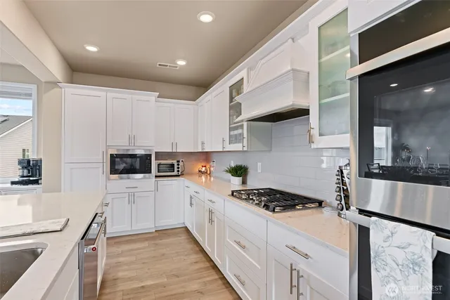 a kitchen with stainless steel appliances kitchen island granite countertop a sink and cabinets