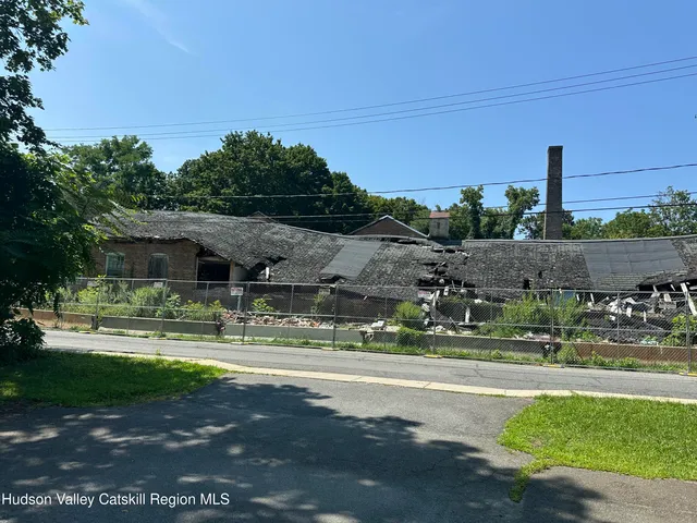 a backyard of a house with a yard and outdoor seating