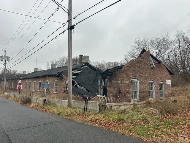 a brick house that has a street sign on it