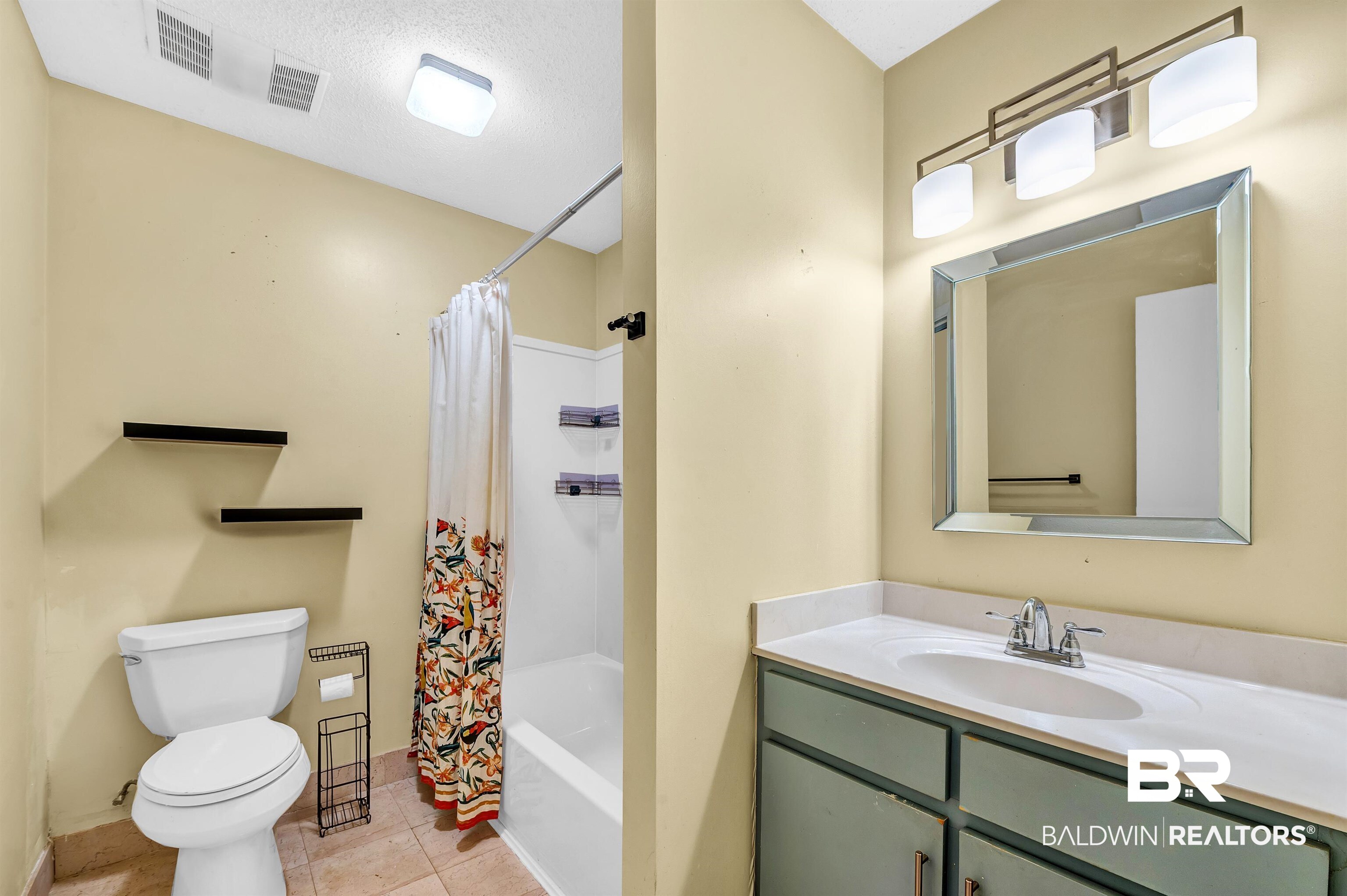 28 Caisson Trace Spanish Fort, AL 36527 - Photo 27 of 51 Full bath featuring shower / bath combo with shower curtain, toilet, vanity, baseboards