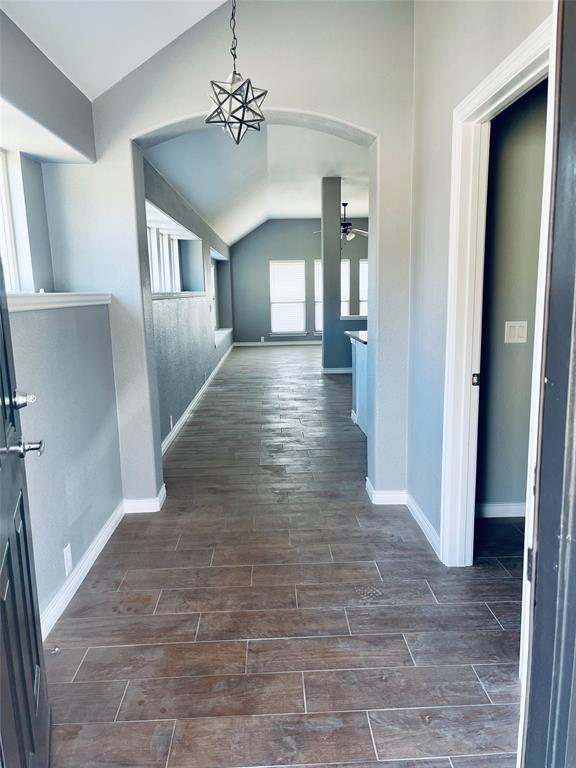 548 Kerry Street Crowley, TX 76036 - Photo 3 of 35 a view of a hallway with wooden floor and a living room