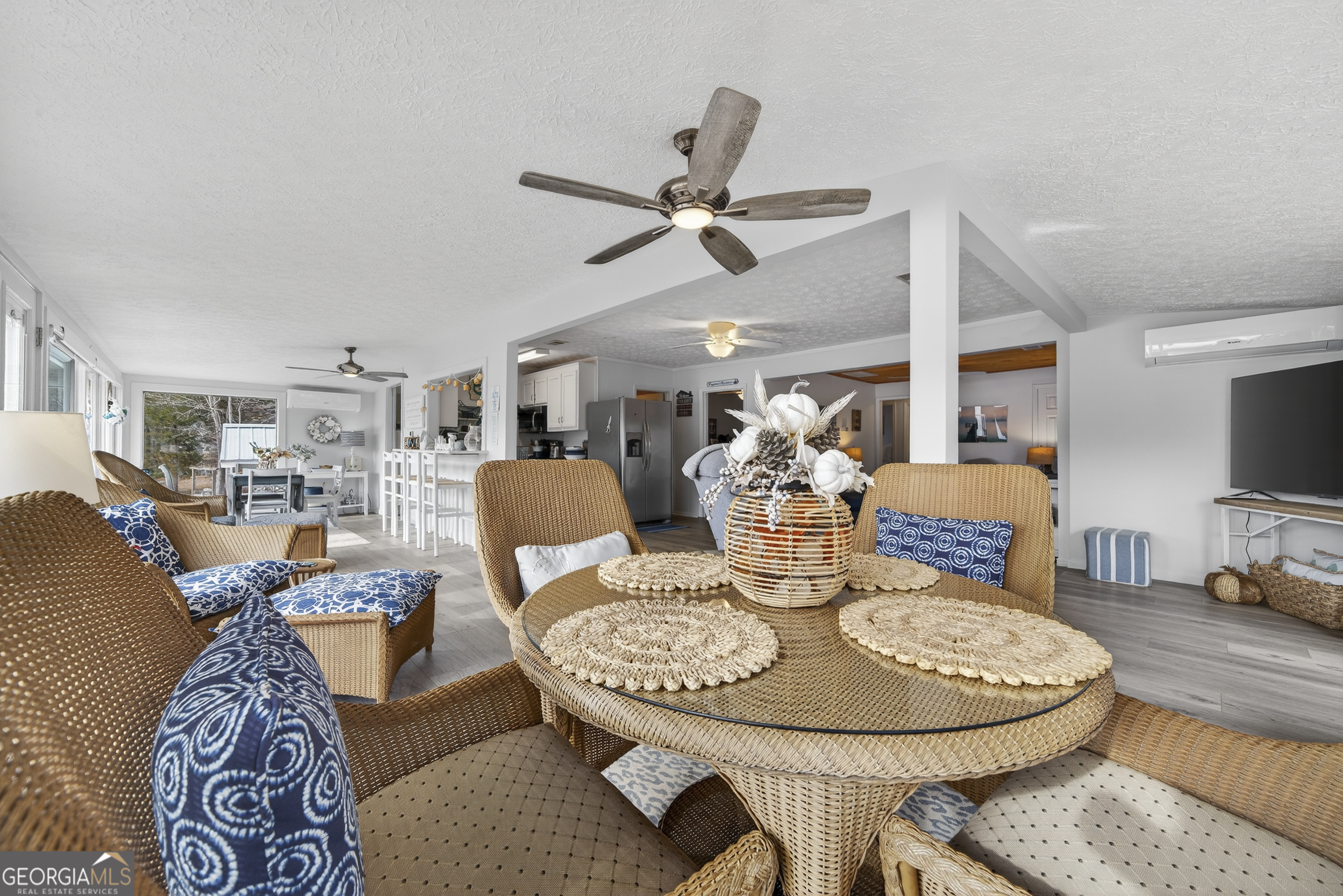 285 Clubhouse Road Eatonton, GA 31024 - Photo 15 of 44 a living room with furniture a table and kitchen view