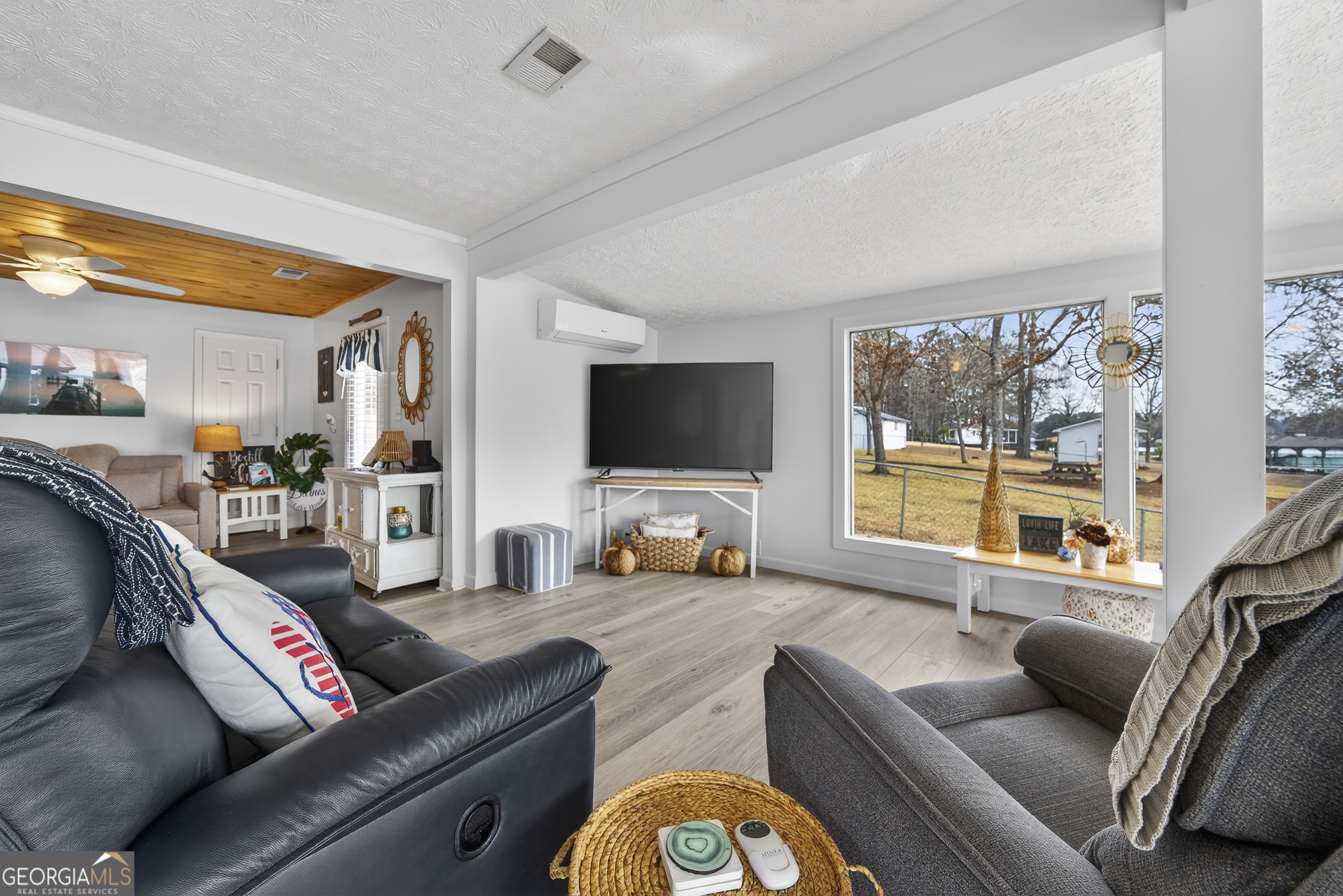 285 Clubhouse Road Eatonton, GA 31024 - Photo 16 of 44 a living room with furniture and a flat screen tv