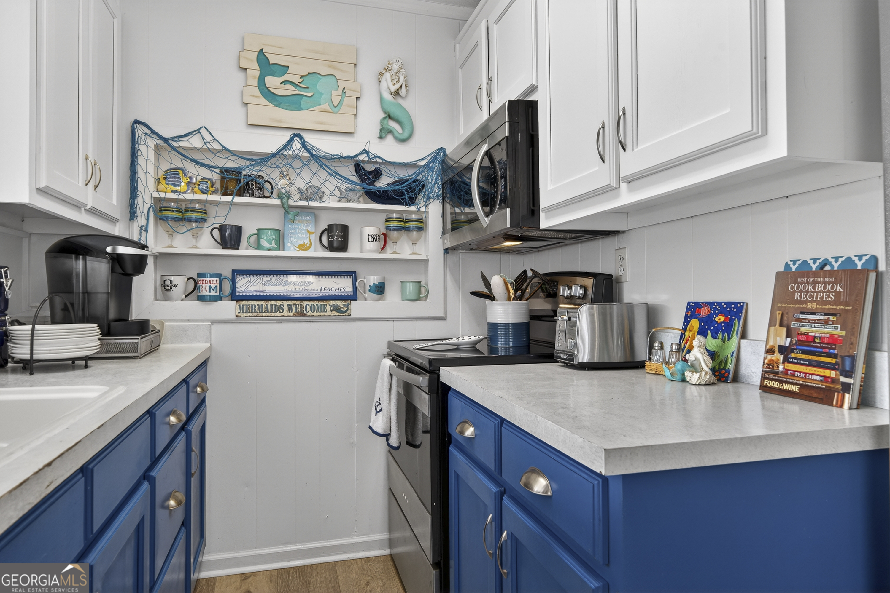 285 Clubhouse Road Eatonton, GA 31024 - Photo 20 of 44 a kitchen with stainless steel appliances granite countertop a sink and dishwasher a stove top oven with white cabinets