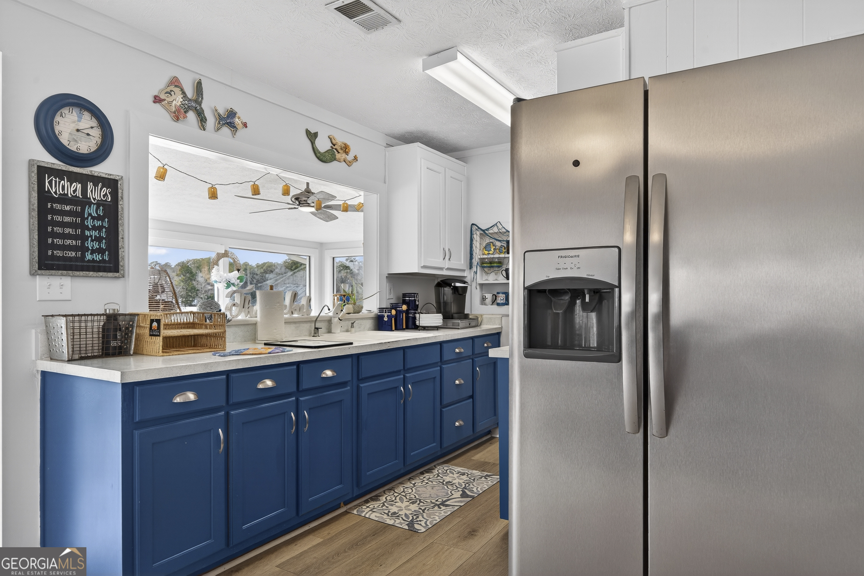 285 Clubhouse Road Eatonton, GA 31024 - Photo 22 of 44 a kitchen with stainless steel appliances granite countertop a refrigerator and a sink