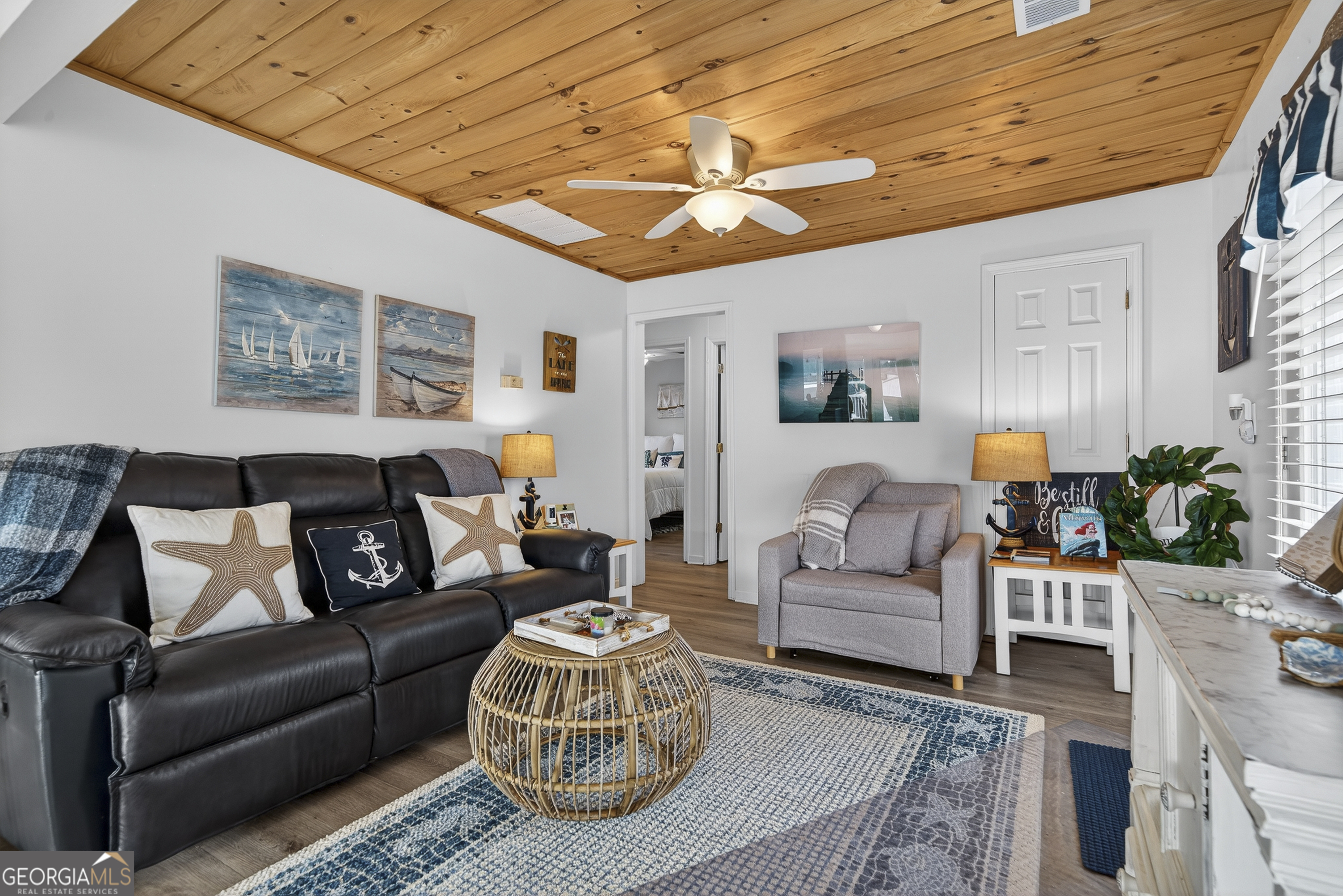 285 Clubhouse Road Eatonton, GA 31024 - Photo 24 of 44 a living room with furniture and a chandelier