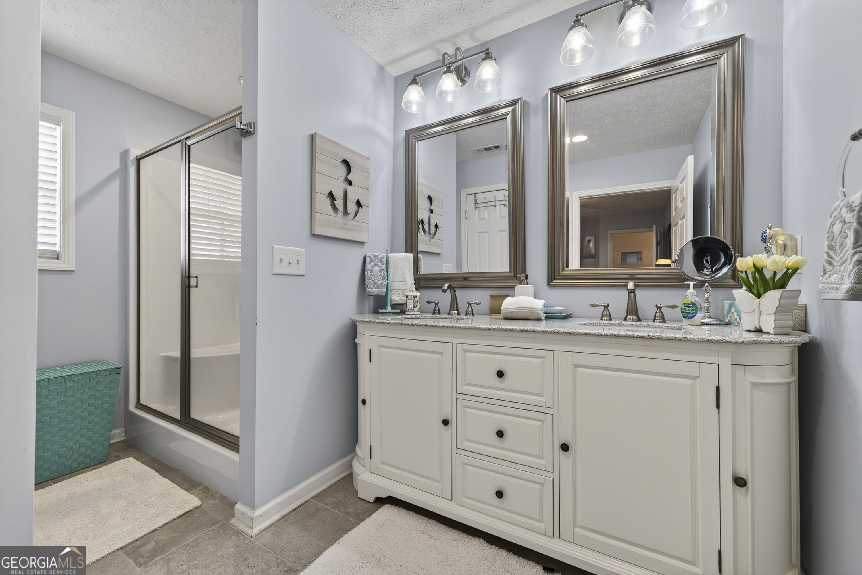 285 Clubhouse Road Eatonton, GA 31024 - Photo 27 of 44 a bathroom with double sink and a mirror