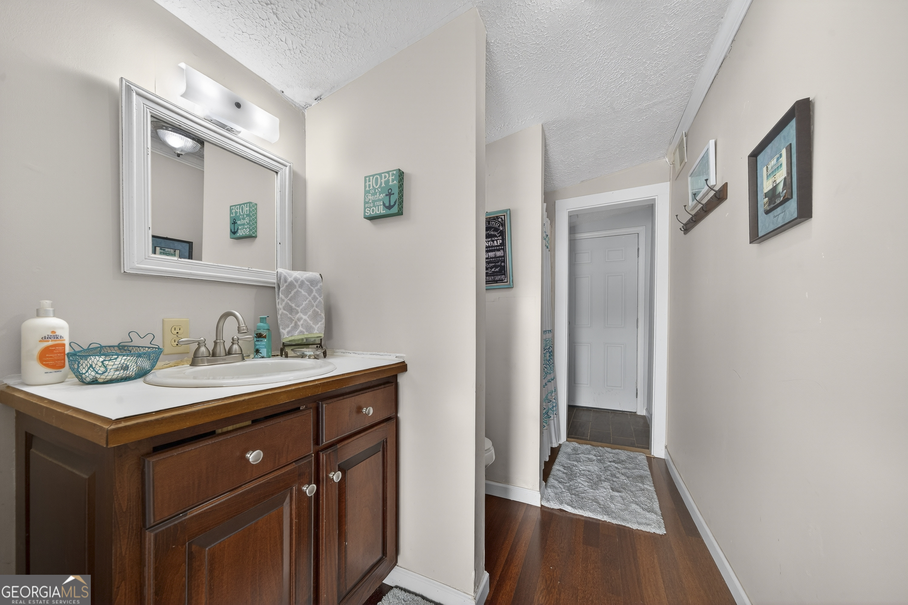 285 Clubhouse Road Eatonton, GA 31024 - Photo 32 of 44 a bathroom with a granite countertop sink and a mirror
