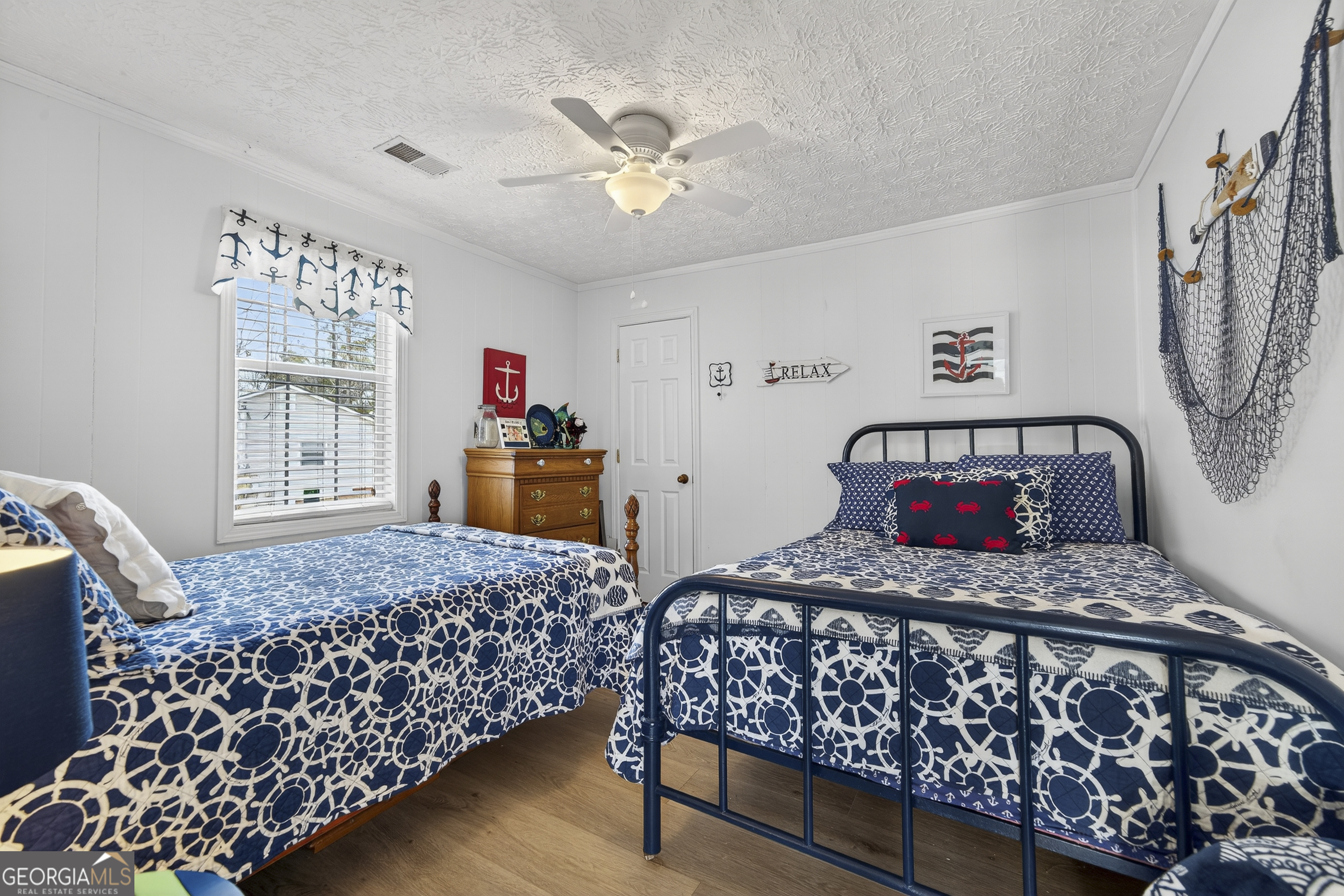 285 Clubhouse Road Eatonton, GA 31024 - Photo 34 of 44 a bedroom with bed and wooden floor