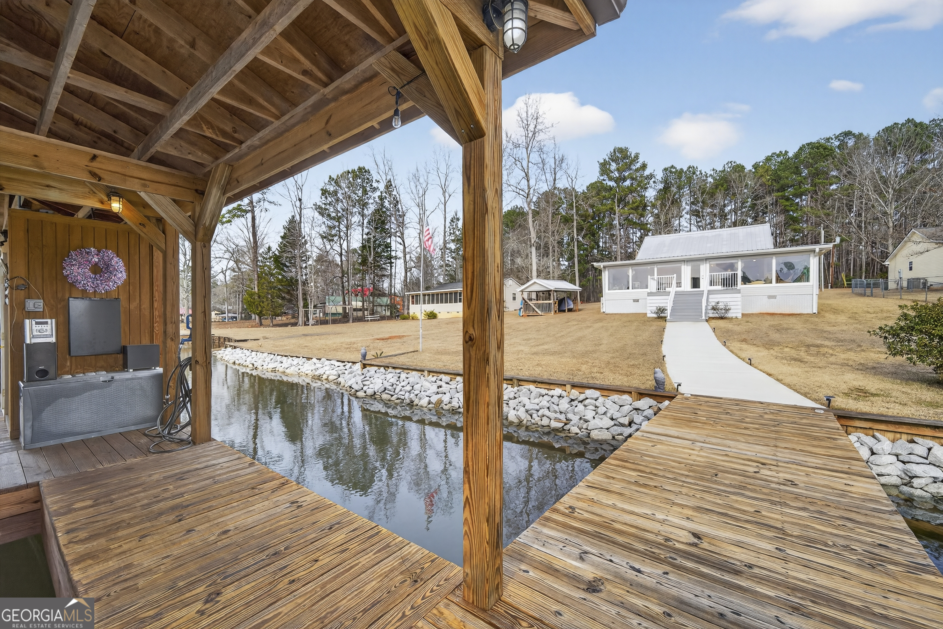 285 Clubhouse Road Eatonton, GA 31024 - Photo 5 of 44 a view of a porch with wooden floor