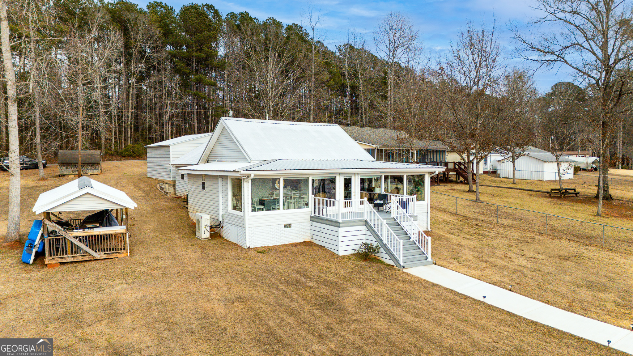 285 Clubhouse Road Eatonton, GA 31024 - Photo 9 of 44 a view of a house with backyard and sitting area