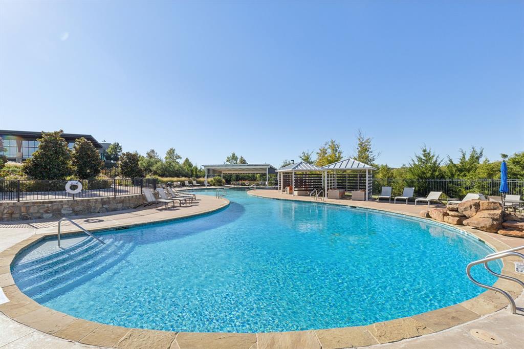 1918 Holy Unity Lane Wylie, TX 75098 - Photo 17 of 19 a view of a swimming pool with an outdoor seating and a garden