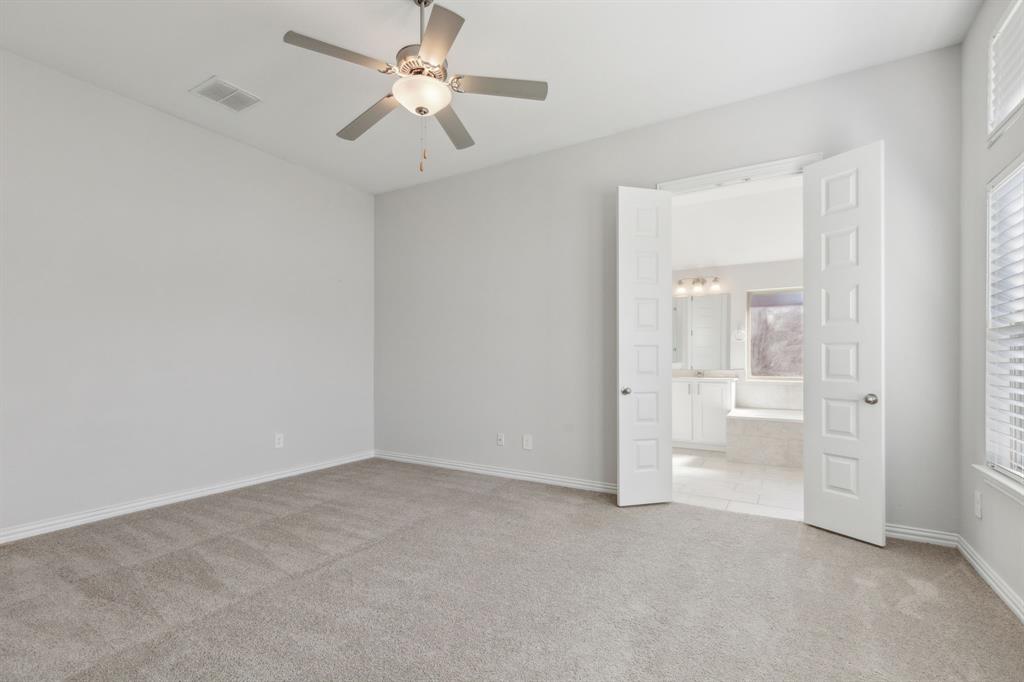 1918 Holy Unity Lane Wylie, TX 75098 - Photo 6 of 19 wooden floor in an empty room with a bathroom