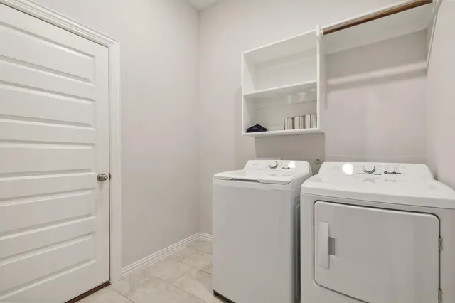 a view of storage and utility room with washer and dryer