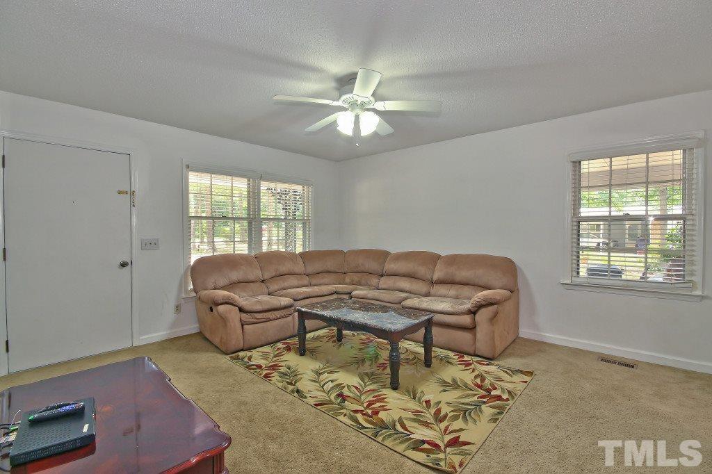1632 Marshburn Road Wendell, NC 27591 - Photo 5 of 19 Inviting living room features carpet and a ceiling fan.