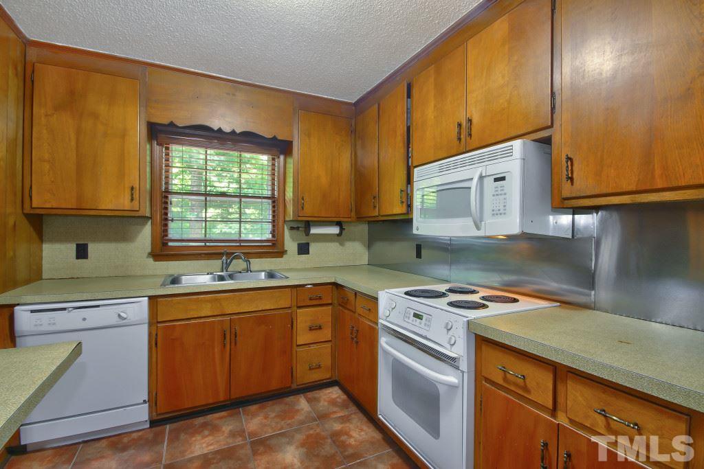 1632 Marshburn Road Wendell, NC 27591 - Photo 9 of 19 Kitchen includes electric self cleaning range, double sink w/microwave. Also has a dishwasher and refrigerator does convey.
