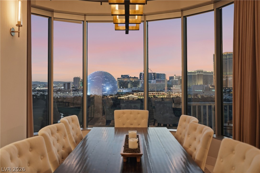 360 East Desert Inn Road, Unit 1701 Las Vegas, NV 89109 - Photo 28 of 33 A formal dining room offers panoramic city views through a curved wall of windows.