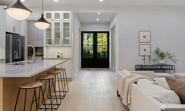 a kitchen with refrigerator and cabinets