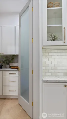 a kitchen with stainless steel appliances granite countertop sink microwave and white cabinets