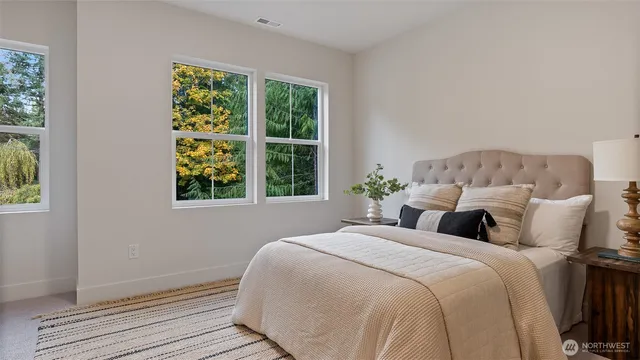 a bed sitting in a bedroom next to a window